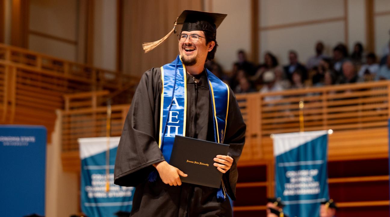 student walking the stage