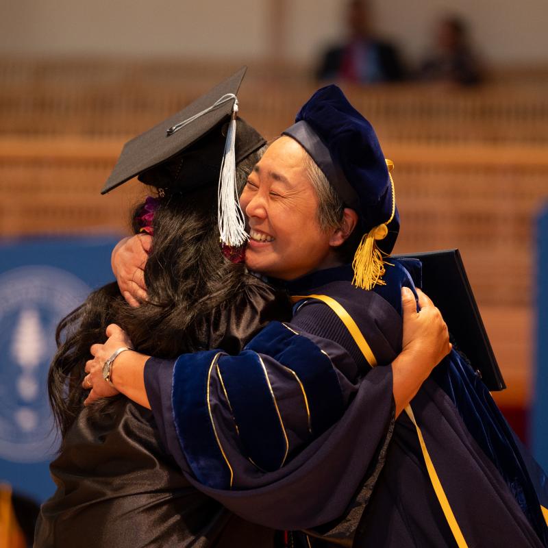 graduate hugging professor