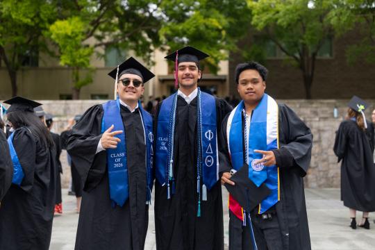 graduates posing together